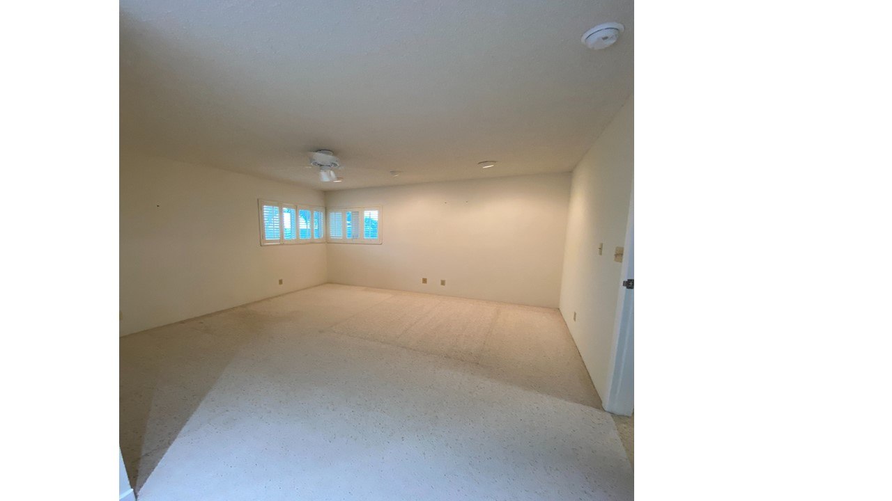 A room with a white ceiling and a window with blinds.